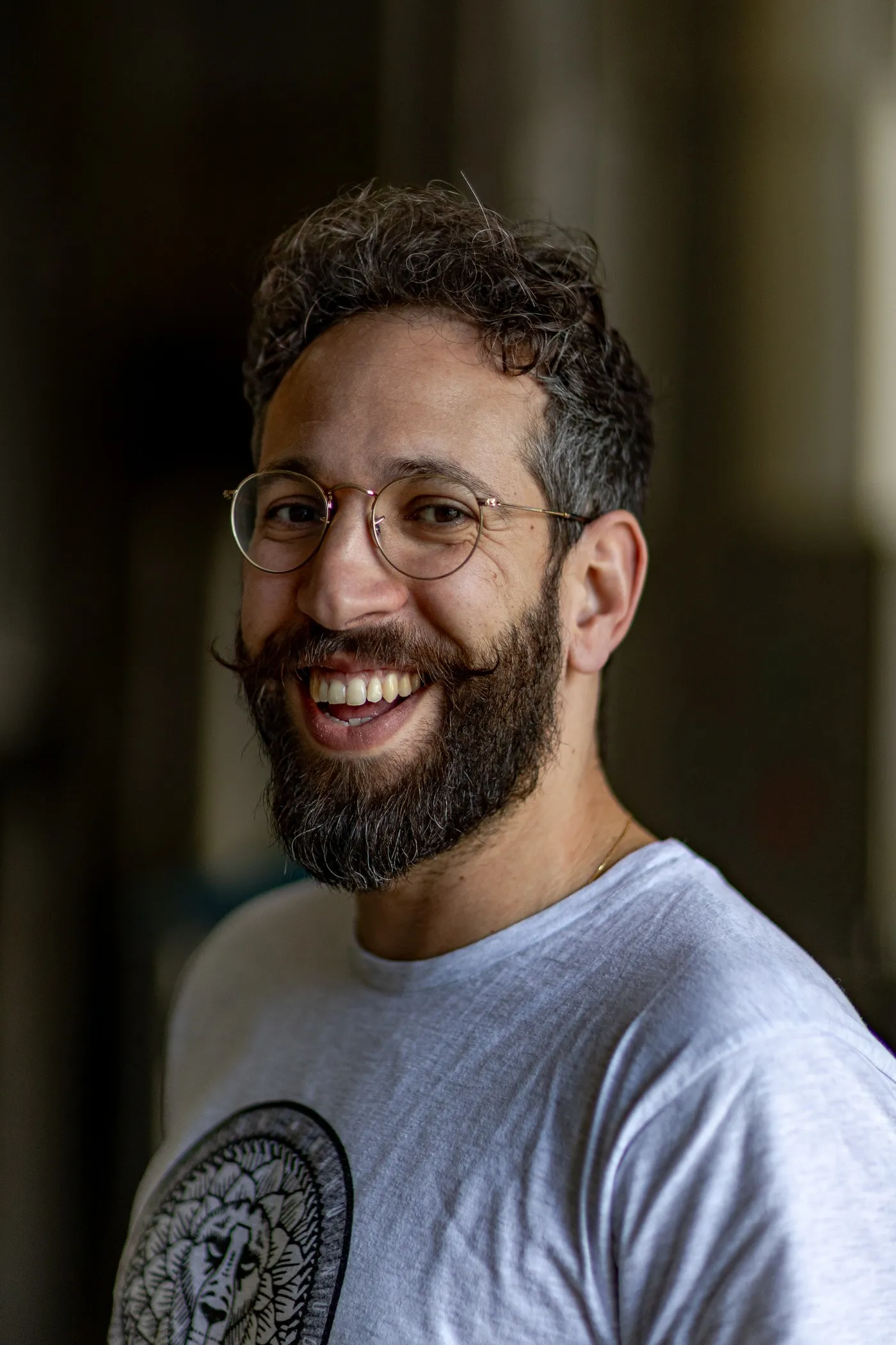 Smiling bearded brewer with round glasses in the brewery, portrait for La Canute Lyonnaise